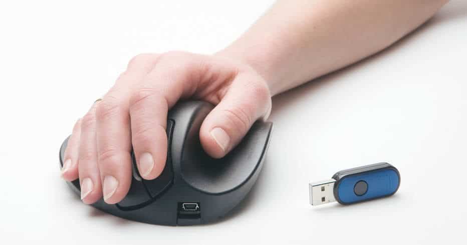 A big and large hand holding an ergonomic computer mouse.